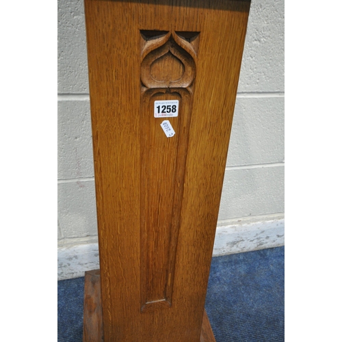 1258 - A 20TH CENTURY OAK CHURCH COLLECTION BOX, with a raised back, small money slot, raised on a tapered ... 