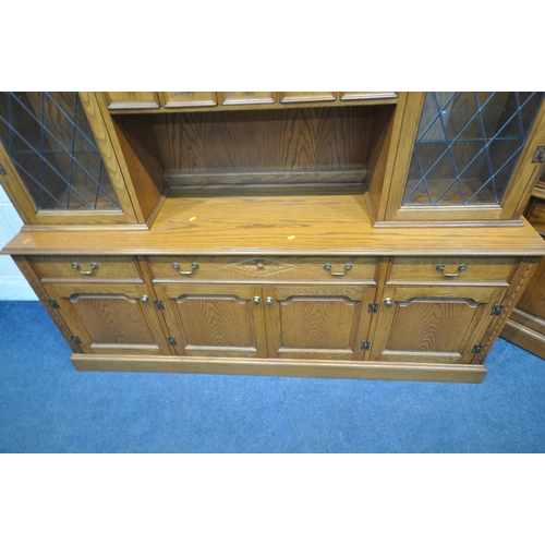 1267 - A 20TH CENTURY OAK JAYCEE DRESSER, the top with double lead glazed doors, that are enclosing glass s... 