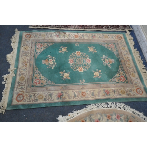 1273 - A GREEN GROUND CHINESE WOOLEN RUG,, with multi-strap border, 194cm x 123cm, an oval rug, along with ... 