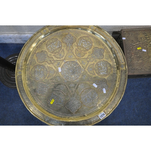 1274 - AN ISLAMIC ENGRAVED BRASS TRAY TABLE, on a folding wooden base, with mother of pearl inlay, diameter... 