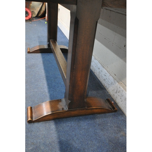 1282 - A 20TH CENTURY OAK REFECTORY TABLE, raised on chamfered block supports, shaped feet, united by a blo... 