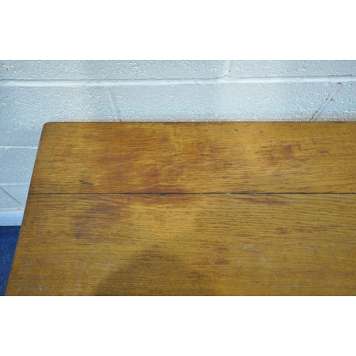 1283 - A 20TH CENTURY OAK REFECTORY TABLE, raised on four block supports, shaped feet, united by a stretche... 