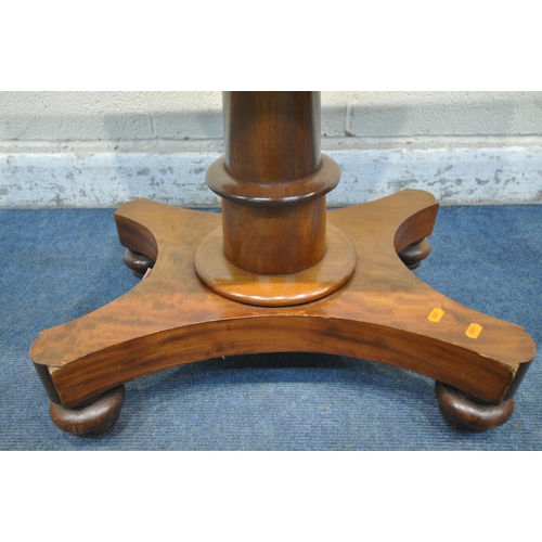 1290 - A REGENCY MAHOGANY TEA TABLE, the revolving fold over top enclosing a small storage section, on a cy... 