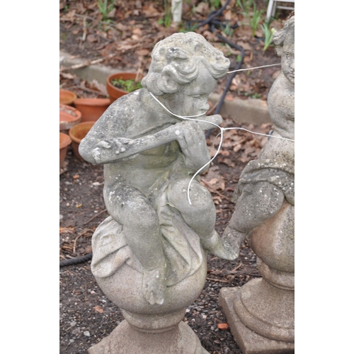 1009 - A SET OF THREE MOULDED GARDEN FIGURES IN THE FORM OF CHILDREN EACH PLAYING A MUSICAL INSTRUMENT PERC... 