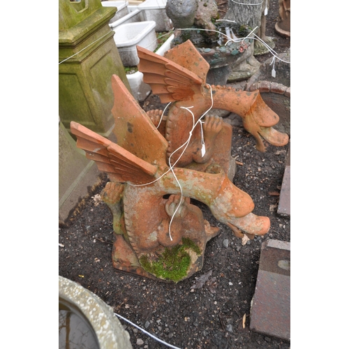 1019 - A PAIR OF DRAGON RIDGE TILES in terracotta height 63cm (Condition Report: cracks to wings on one and... 