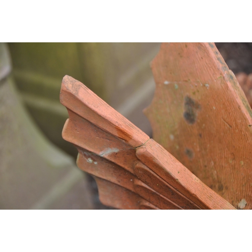 1019 - A PAIR OF DRAGON RIDGE TILES in terracotta height 63cm (Condition Report: cracks to wings on one and... 