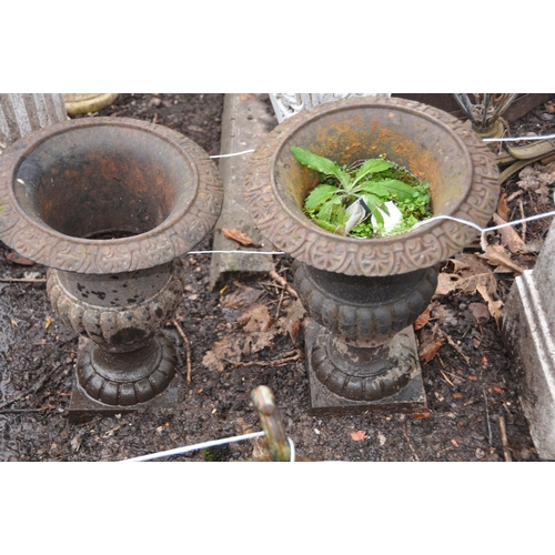 1022 - A PAIR OF EARLY 20th CENTURY CAST IRON GARDEN URNS with fluted baluster bowl height 46cm and a simil... 