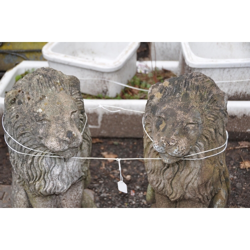 1029 - A PAIR OF MODERN COMPOSITE LION GARDEN FIGURES in seated pose height 57cm(2)