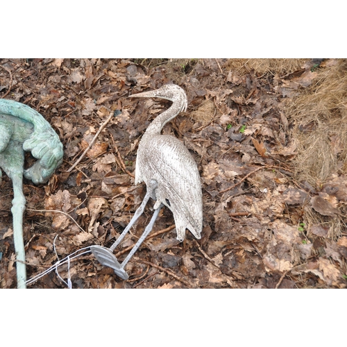 1031 - A LARGE METAL FIGURE OF A FLAMINGO appears to be painted copper with brass feet and a plastic Heron ... 