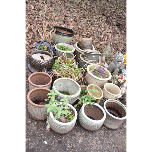 1034 - A COLLECTION OF GLAZED PLANT POTS in blues, greens and earth colours the largest green pot 47cm in d... 