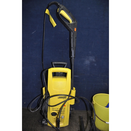 1064 - A KARCHER K2.54 PRESSURE WASHER with lance and two brush attachments, a Karcher Window vac in origin... 