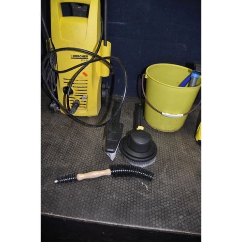 1064 - A KARCHER K2.54 PRESSURE WASHER with lance and two brush attachments, a Karcher Window vac in origin... 