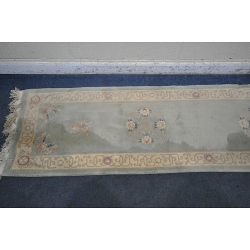 1292 - A CHINESE MINT GREEN GROUND RUNNER, with two medallions, with beige border, 310cm x 76cm (condition ... 