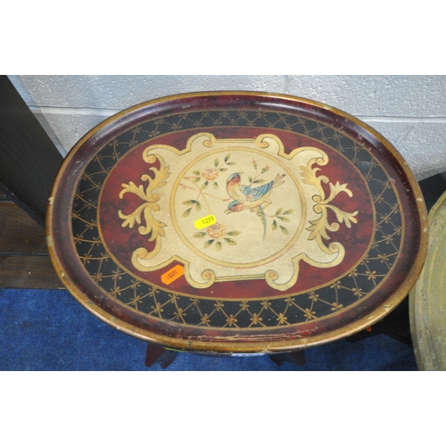 1299 - A BURGUNDY ORIENTAL STYLE OVAL TELEPHONE TABLE, with scrolled detail and bird decoration, on four ca... 