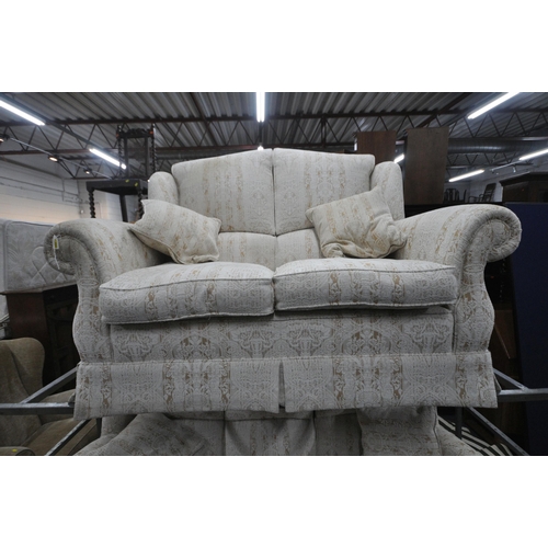 1310 - WADE UPHOLSTERY, A BEIGE UPHOLSTERED TWO PIECE LOUNGE SUITE, comprising a three seater sofa, along w... 