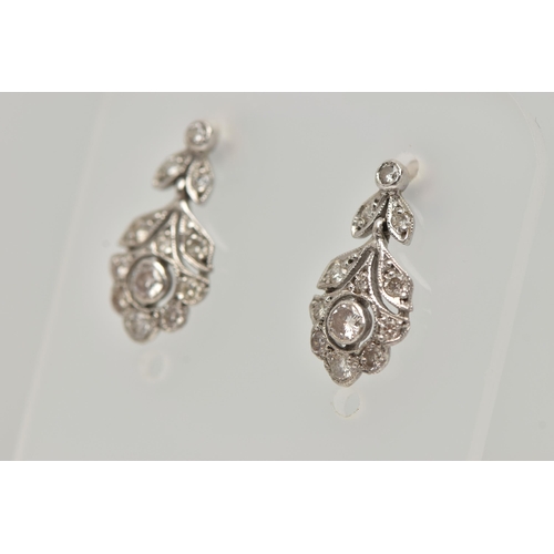 13 - A PAIR OF WHITE METAL, DIAMOND DROP EARRINGS, each earring set with a central round brilliant cut di... 