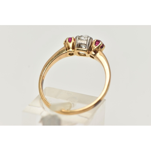 20 - A YELLOW METAL DIAMOND AND RUBY THREE STONE RING, centering on an old cut diamond, estimated diamond... 