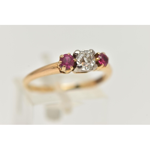 20 - A YELLOW METAL DIAMOND AND RUBY THREE STONE RING, centering on an old cut diamond, estimated diamond... 