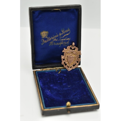 3 - A LATE VICTORIAN 9CT GOLD FOB MEDAL, shield shape with engraved monogram, engraved to the reverse 'W... 