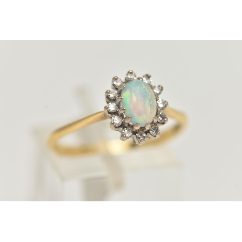 39 - AN OPAL AND DIAMOND CLUSTER RING, the central oval opal cabochon within a single cut diamond surroun... 