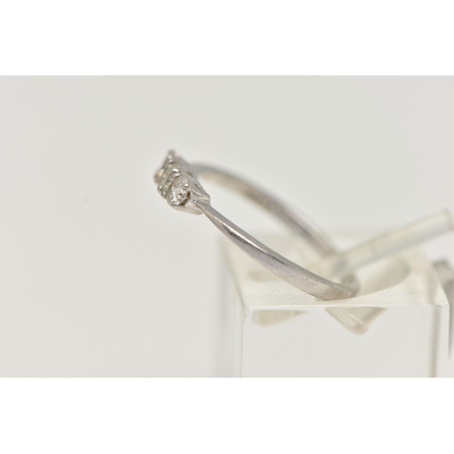 44 - A PLATINUM THREE STONE DIAMOND RING, designed as a line of three brilliant cut diamonds in claw sett... 