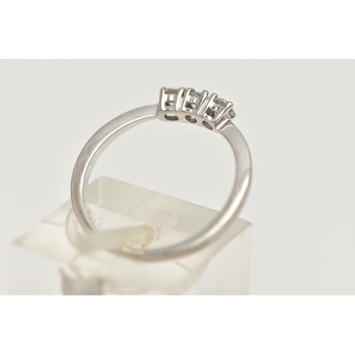 44 - A PLATINUM THREE STONE DIAMOND RING, designed as a line of three brilliant cut diamonds in claw sett... 