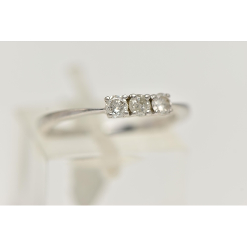 44 - A PLATINUM THREE STONE DIAMOND RING, designed as a line of three brilliant cut diamonds in claw sett... 