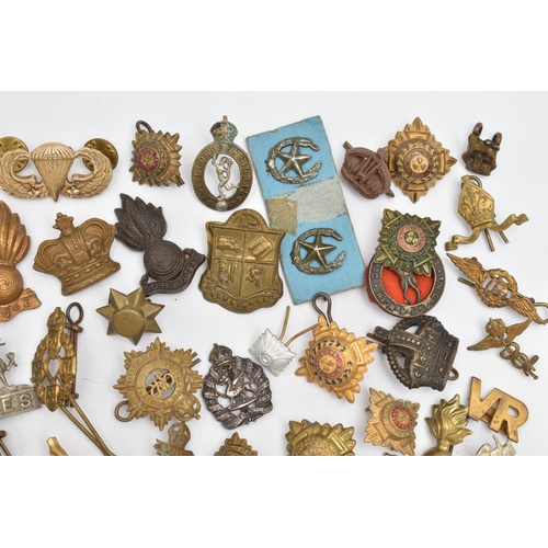 83 - AN ASSORTMENT OF MILITARY CAP BADGES AND PINS, brass badges from assorted British regiments