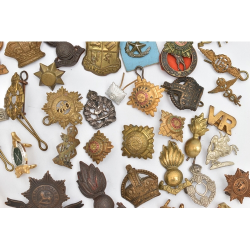 83 - AN ASSORTMENT OF MILITARY CAP BADGES AND PINS, brass badges from assorted British regiments