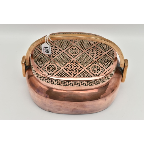 100 - AN ORIENTAL COPPER AND BRASS HAND WARMER, engraved design to one side, pierced cover and fitted with... 