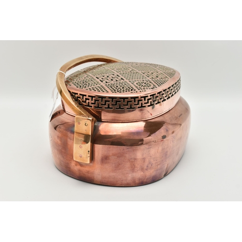 100 - AN ORIENTAL COPPER AND BRASS HAND WARMER, engraved design to one side, pierced cover and fitted with... 