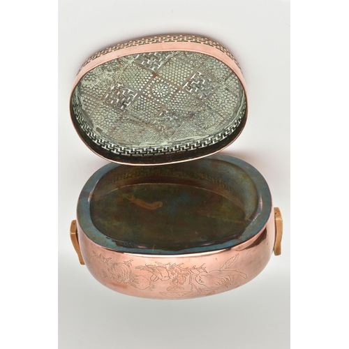 100 - AN ORIENTAL COPPER AND BRASS HAND WARMER, engraved design to one side, pierced cover and fitted with... 