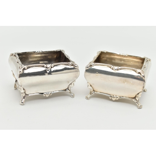 90 - A PAIR OF GEORGE V SILVER SALTS, each of a rectangular form with swag detail to the rim, raised on f... 