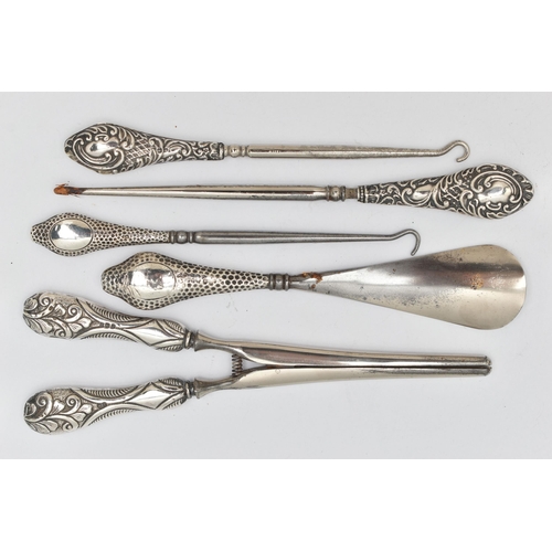 95 - FIVE SILVER HANDLED ITEMS, to include three button hooks, a shoe horn and a pair of glove stretchers... 