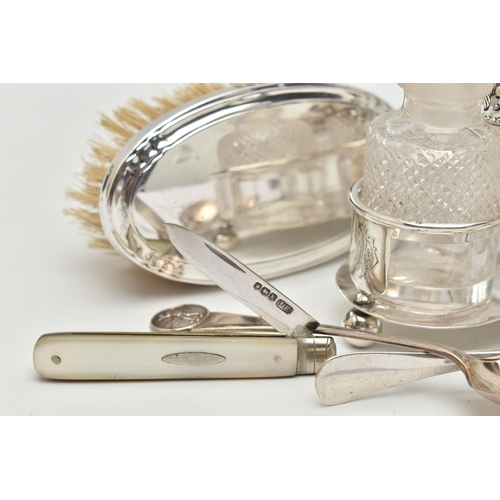 99 - A SMALL ASSORTMENT OF SILVER ITEMS, to include a three piece cruet set with stand, comprising of a g... 