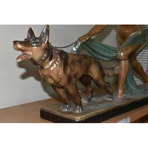 324 - A LARGE ART DECO PATINATED PLASTER SCULPTURE, a figure of a nude female and Alsatian dog, width 70cm... 