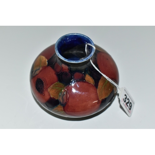 329 - A MOORCROFT 'POMEGRANITE' DESIGN SQUAT VASE,  purple pomegranate on a dark blue ground, height 7cm, ... 