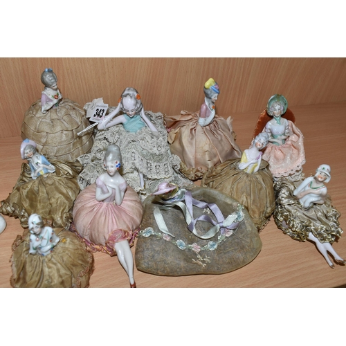 343 - A GROUP OF LATE 19TH AND EARLY 20TH CENTURY PORCELAIN PIN DOLLS, nine pin cushion dolls and one lave... 