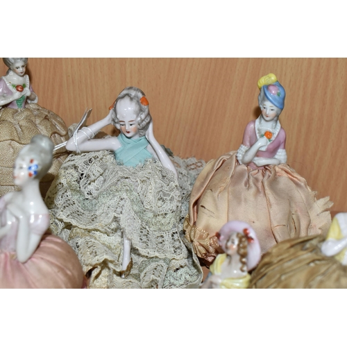 343 - A GROUP OF LATE 19TH AND EARLY 20TH CENTURY PORCELAIN PIN DOLLS, nine pin cushion dolls and one lave... 