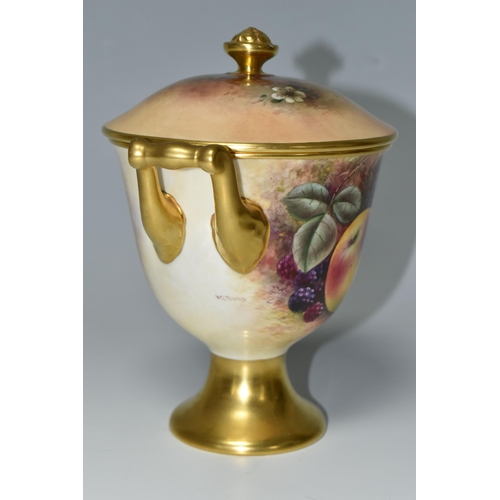 364 - A COALPORT COVERED VASE, the gilt footed vase with twin gilt handles, hand painted with apples, blac... 