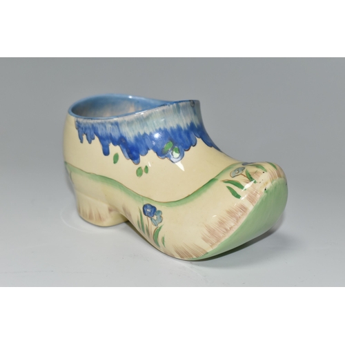 365 - A CLARICE CLIFF SMALL SABOT/CLOG, in Taomina pattern, painted with blue stylised trees in a coastal ... 