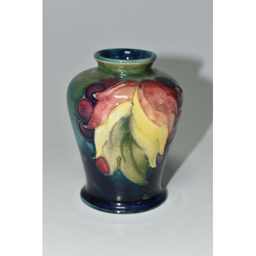 372 - A MOORCROFT POTTERY 'LEAF AND BERRY' PATTERN VASE, of small shouldered form, tube lined with multico... 