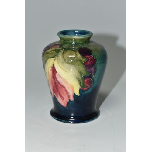 372 - A MOORCROFT POTTERY 'LEAF AND BERRY' PATTERN VASE, of small shouldered form, tube lined with multico... 