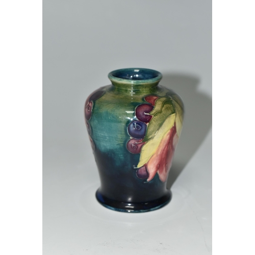 372 - A MOORCROFT POTTERY 'LEAF AND BERRY' PATTERN VASE, of small shouldered form, tube lined with multico... 