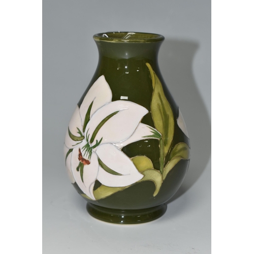 375 - A MOORCROFT POTTERY 'BERMUDA LILY' PATTERN BALUSTER VASE, tube lined with white lilies on a green gr... 