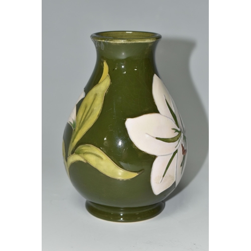 375 - A MOORCROFT POTTERY 'BERMUDA LILY' PATTERN BALUSTER VASE, tube lined with white lilies on a green gr... 