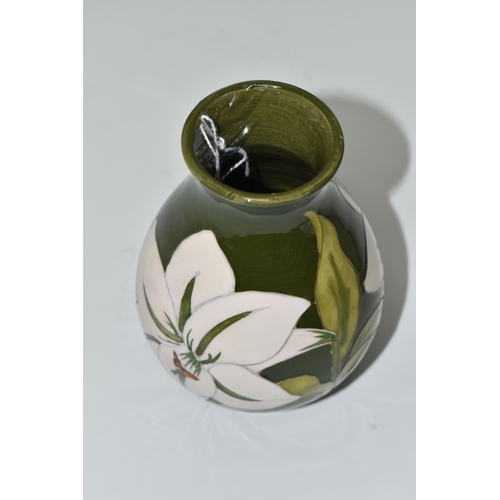 375 - A MOORCROFT POTTERY 'BERMUDA LILY' PATTERN BALUSTER VASE, tube lined with white lilies on a green gr... 