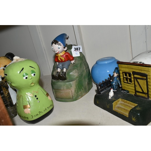 387 - A COLLECTION OF MONEY BOXES, including a vintage plastic Noddy Money box, a reproduction cast iron m... 