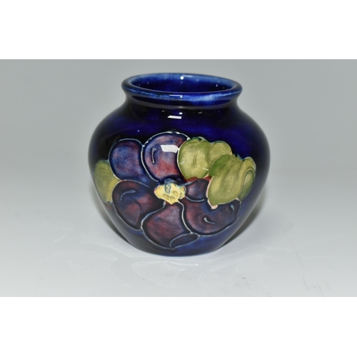 394 - A MOORCROFT POTTERY SQUAT BALUSTER VASE, decorated with Clematis on a blue ground, impressed and pai... 