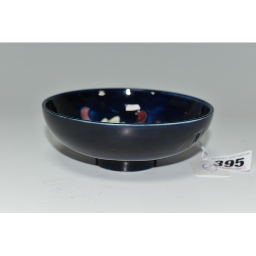 395 - A MOORCROFT POTTERY SMALL FOOTED BOWL, decorated with Columbine on a blue ground, impressed and pain... 